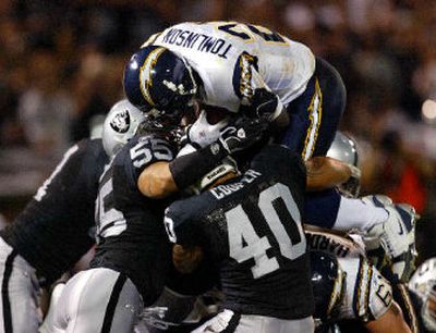 
Oakland had trouble brining down San Diego's LaDainian Tomlinson the whole night. Here he scores a one-yard run. 
 (Associated Press / The Spokesman-Review)