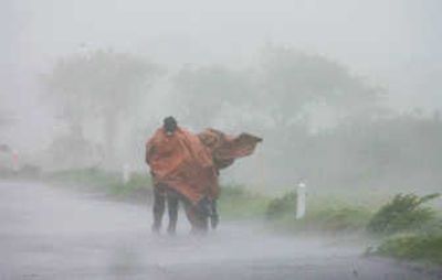 
People walk along a highway as Hurricane Dean makes landfall Wednesday near Martinez de la Torre, Mexico. The hurricane hit the Mexican mainland with maximum winds reaching 100 mph. Associated Press
 (Associated Press / The Spokesman-Review)