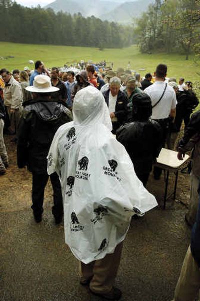 People waiting on President Bush's arrival at Cades Cove, Tenn., begin to exit the site Friday after the Earth Day event was canceled due to thunderstorms in the area.
(Associated Press / The Spokesman-Review)