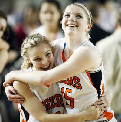Sareya Bishop, left, and Julia Moravec celebrate Lewis and Clark’s fourth state title in six years. (Patrick Hagerty)