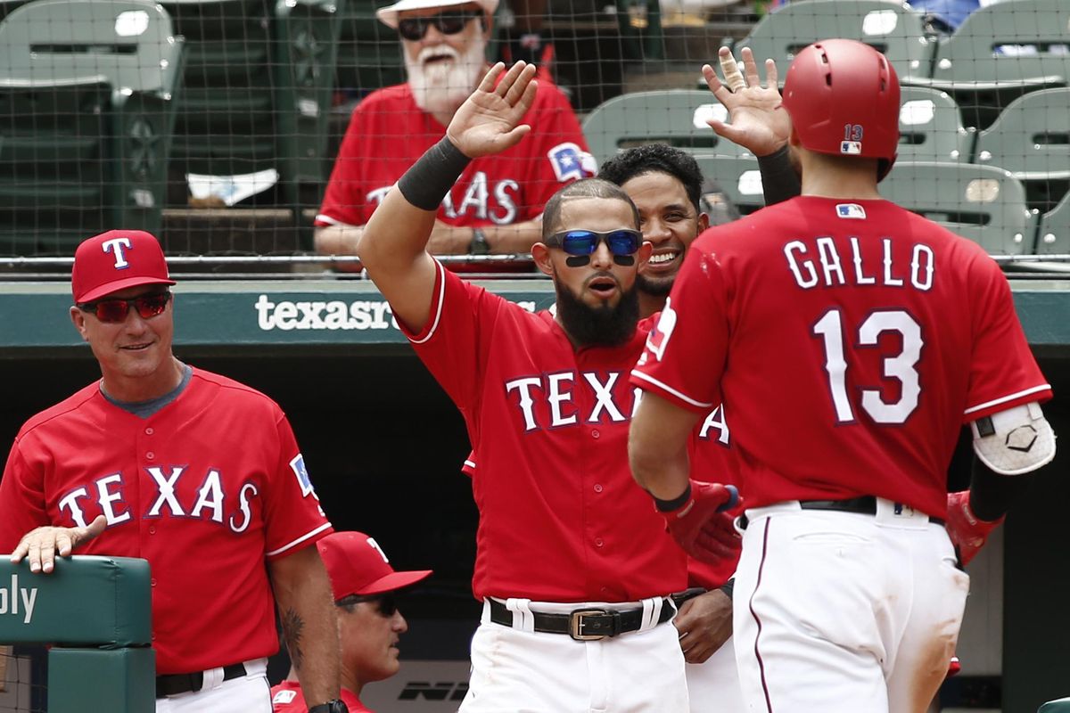 From left, Texas Rangers manager Jeff Banister, Rougned Odor and Elvis Andrus congratulate Joey Gallo (13) after his second home run against the Seattle Mariners during the fifth inning of a baseball game Wednesday, Aug. 8, 2018, in Arlington, Texas. (Mike Stone / AP)