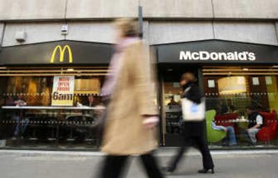 
Londoners pass a McDonald's on Monday. McDonald's and two other large corporations will be able to award high-school credits as part of a plan to improve young people's skills, the British government announced Monday. Associated Press
 (Associated Press / The Spokesman-Review)