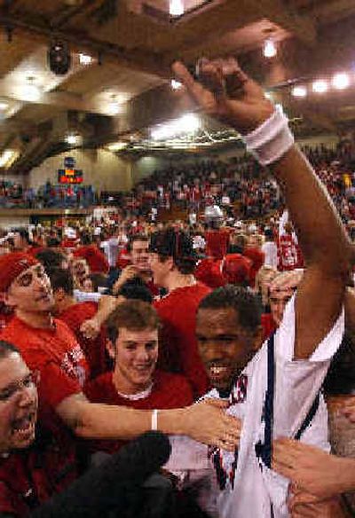 
Paul Marigney, right, is mobbed by fans after scoring 30 points in Saint Mary's first win over a ranked team since 1974.  
 (Associated Press / The Spokesman-Review)