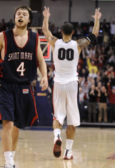 Gonzaga's Robert Sacre celebrates the Zags' last second basket in the first half much to the agony of St. Mary's Matthew Dellaved, Feb. 11. 2010 at the McCarthy Athletic Center. (Dan Pelle / The Spokesman-Review)