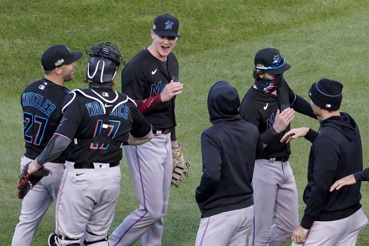 Members of the Miami Marlins celebrate after defeating the Chicago Cubs in Game 2 of a National League wild-card baseball series Friday, Oct. 2, 2020, in Chicago. The Marlins won the series 2-0 to advance to the division series.  (Nam Y. Huh)