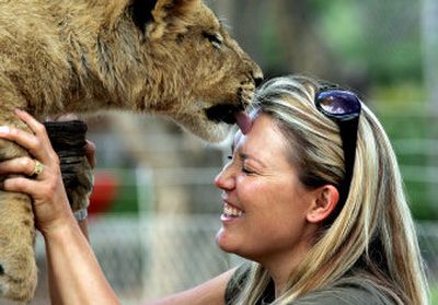 
Marlice van Vuuren plays with a semi-tamed lioness at the Harnas Wildlife Foundation in Namibia. Harnas is home to 310 orphaned animals and offers visitors the chance to get close enough to touch, brush or even walk cheetah, leopards and lions. 
 (The Spokesman-Review)