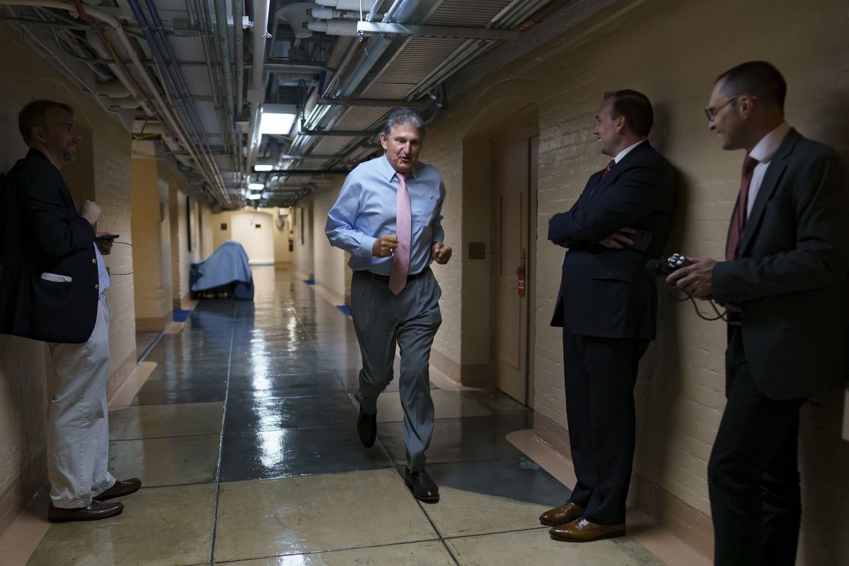 Sen. Joe Manchin, D-W.Va., one of the key Senate infrastructure negotiators, rushes back to a basement room at the Capitol as he and other Democrats work behind closed doors, in Washington, Wednesday, June 16, 2021.  (J. Scott Applewhite)