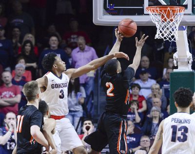 Gonzaga forward Johnathan Williams defends the rim against Pacific guard T. J. Wallace. (Dan Pelle / The Spokesman-Review)