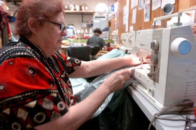 Judith McGiveney sews costumes for the production of