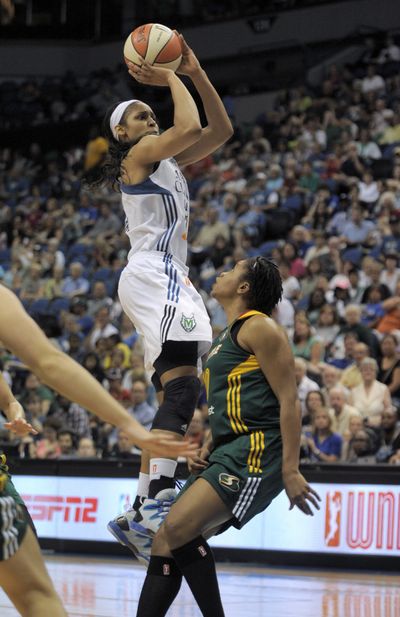 Minnesota’s Maya Moore shoots over Seattle’s Tanisha Wright as the Lynx routed the Storm. (Associated Press)