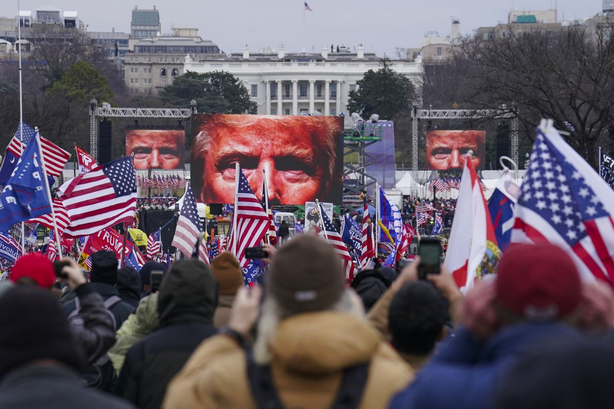 FILE - In this Jan. 6, 2021, file photo, the face of President Donald Trump appears on large screens as supporters participate in a rally in Washington. The House committee investigating the violent Jan. 6 Capitol insurrection, with its latest round of subpoenas in September 2021, may uncover the degree to which former President Donald Trump, his campaign and White House were involved in planning the rally that preceded the riot, which had been billed as a grassroots demonstration.  (John Minchillo)