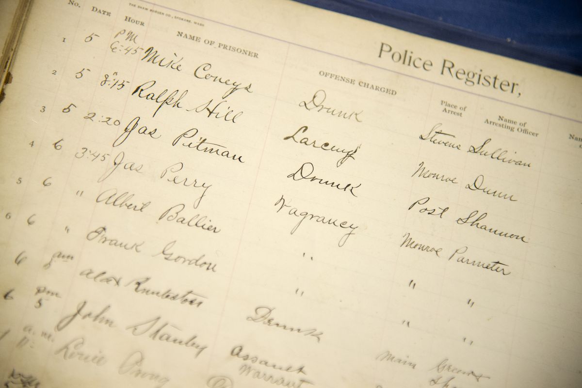 An old police log book, which records arrests for drunkenness and vagrancy, is on display at the Spokane Law Enforcement Museum.