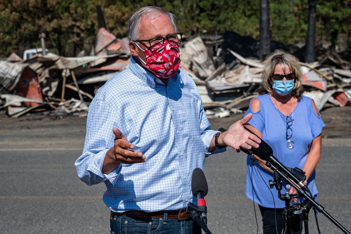After meeting with residents of Malden, Wash., Gov. Jay Inslee and Malden Mayor Chris Ferrell speak in front of the burned remains of the town’s fire station, on Sept. 10.  (Colin Mulvany/THE SPOKESMAN-REVIEW)
