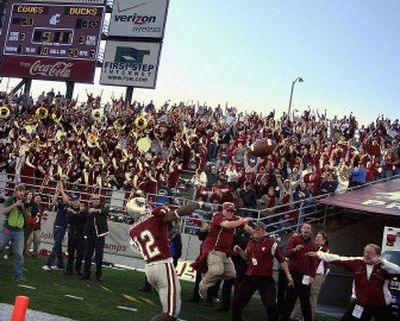 
Washington State cornerback Tyrone Brackenridge throws the ball into the stands at Martin Stadium after intercepting an Oregon pass to start the second half. 
 (Christopher Anderson / The Spokesman-Review)
