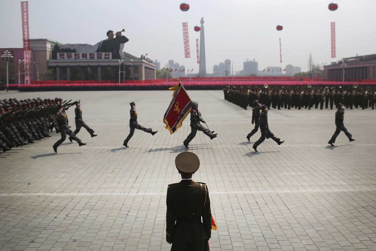 A soldier watches as others march across Kim Il Sung Square during a military parade on Saturday in Pyongyang, North Korea to celebrate the 105th birth anniversary of Kim Il Sung, the country
