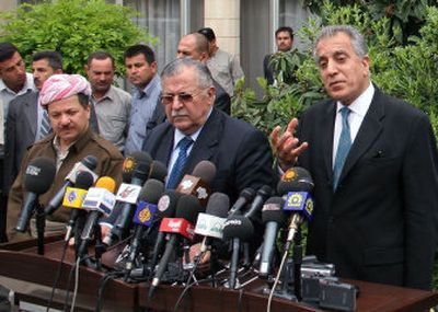 
From left, Kurdish leader Massoud Barazani, Iraqi President Jalal Talabani and U.S. Ambassador Zalmay Khalilzad hold a news conference Sunday in Irbil,  Iraq. 
 (Associated Press / The Spokesman-Review)