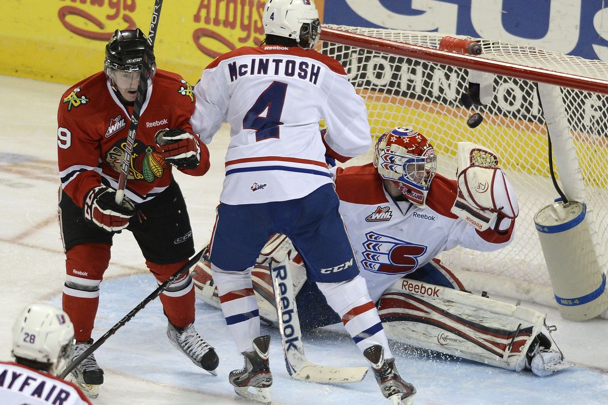 Portland’s Nicolas Petan, left, slips the puck past Spokane goalie Eric Williams for Winterhawks’ second goal. (Colin Mulvany)