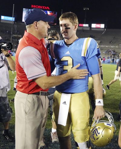 UCLA head coach Jim Mora, left, won’t say if quarterback Josh Rosen, right, will definitely play against Cougars. (Reed Saxon / Associated Press)