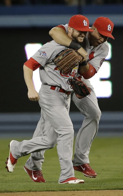 St. Louis Cardinals' Shane Robinson and Carlos Beltran, right, celebrate after Game 4 of the National League baseball championship series against the Los Angeles Dodgers on Tuesday in Los Angeles. (Associated Press)