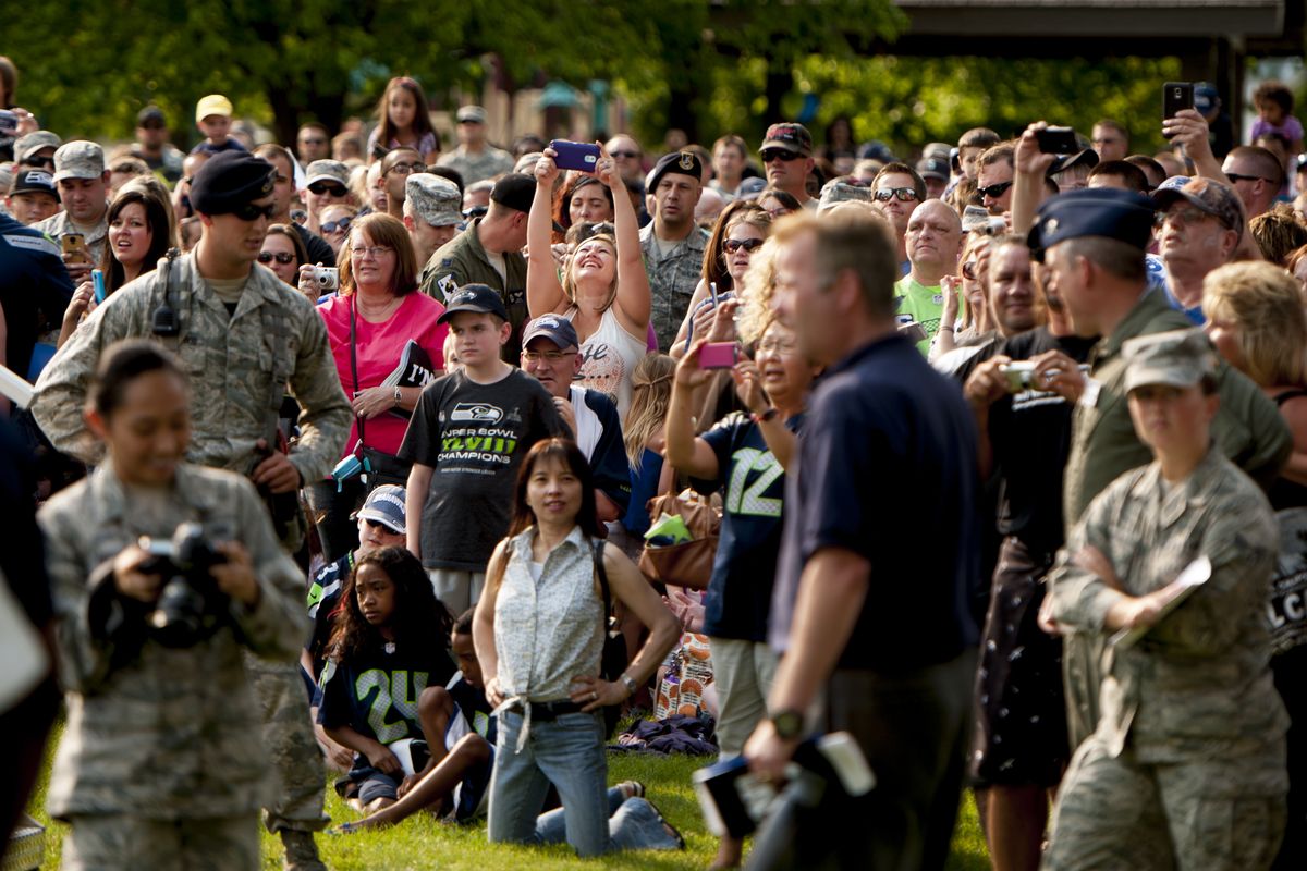 Fans watch as Seahawks team members make an appearance Thursday at Fairchild as part of the team’s “Heroes of 12” military appreciation tour.