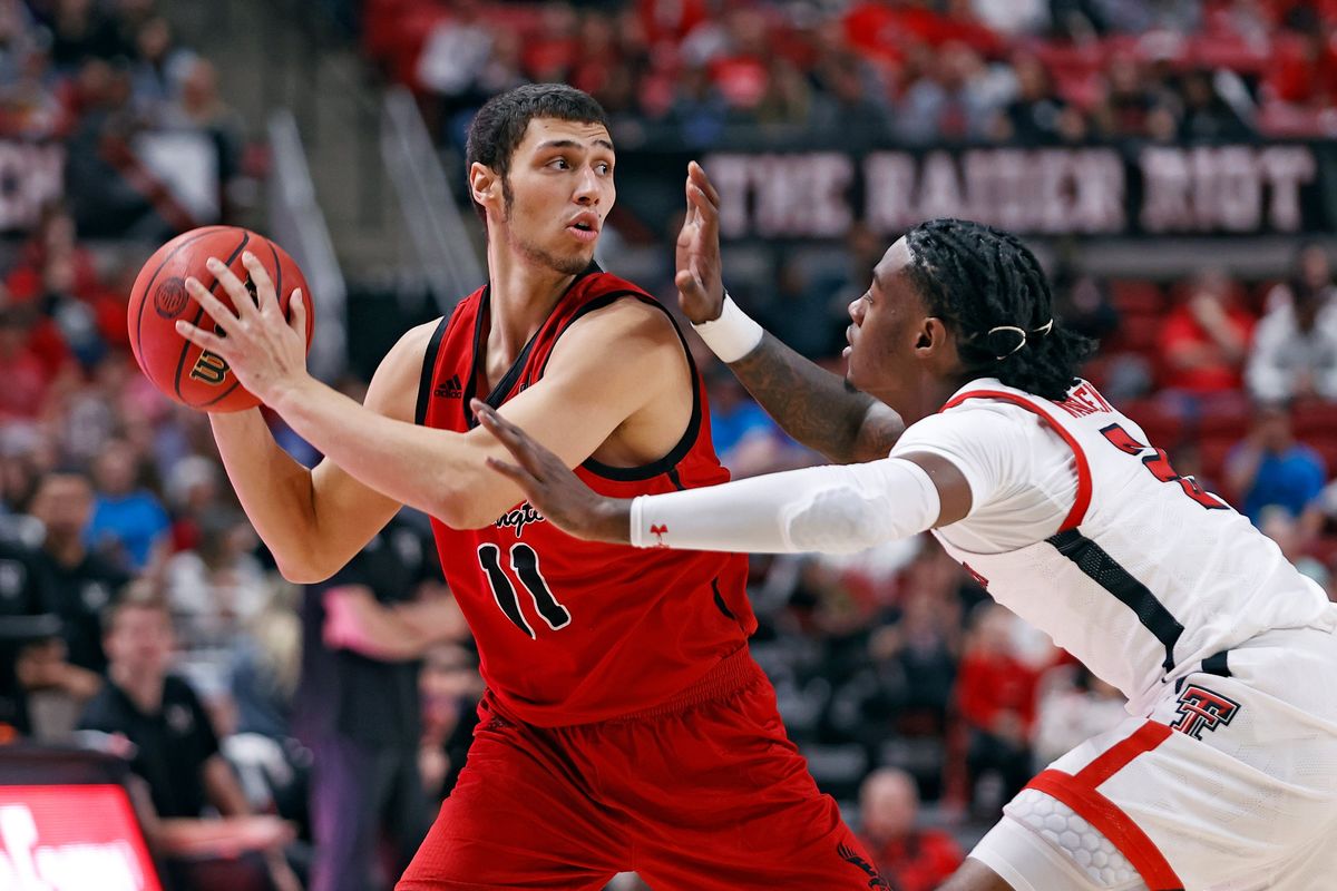 Eastern Washington’s Rylan Bergersen looks to pass around Texas Tech’s Davion Warren on Dec. 22 in Lubbock, Texas.  (Associated Press)