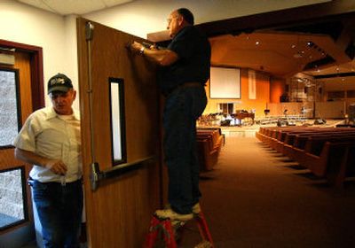 
Warner Kaiser, left, and Mel Phinney work on a  set of doors leading into the auditorium at Valley Assembly of God Church. After two years of construction the expanded sanctuary is almost done. Tours and a dedication and worship celebration are planned for Sunday.
 (Liz Kishimoto / The Spokesman-Review)