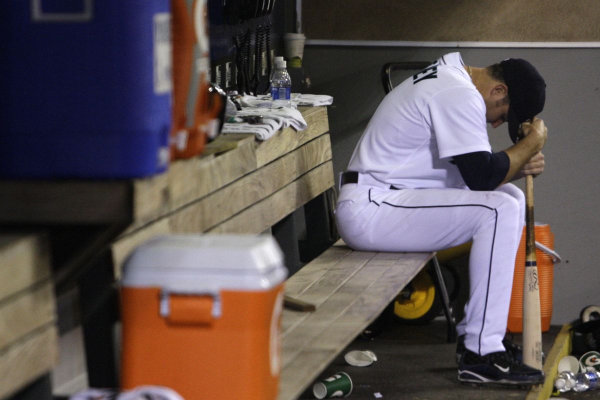 M’s Mike Sweeney sits by himself in the dugout after the game. He grounded out with the bases loaded in the ninth. (Associated Press)