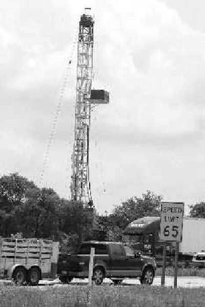 
Traffic on Interstate 35W passes a drilling site inside the city limits of Fort Worth, Texas. 
 (Associated Press / The Spokesman-Review)