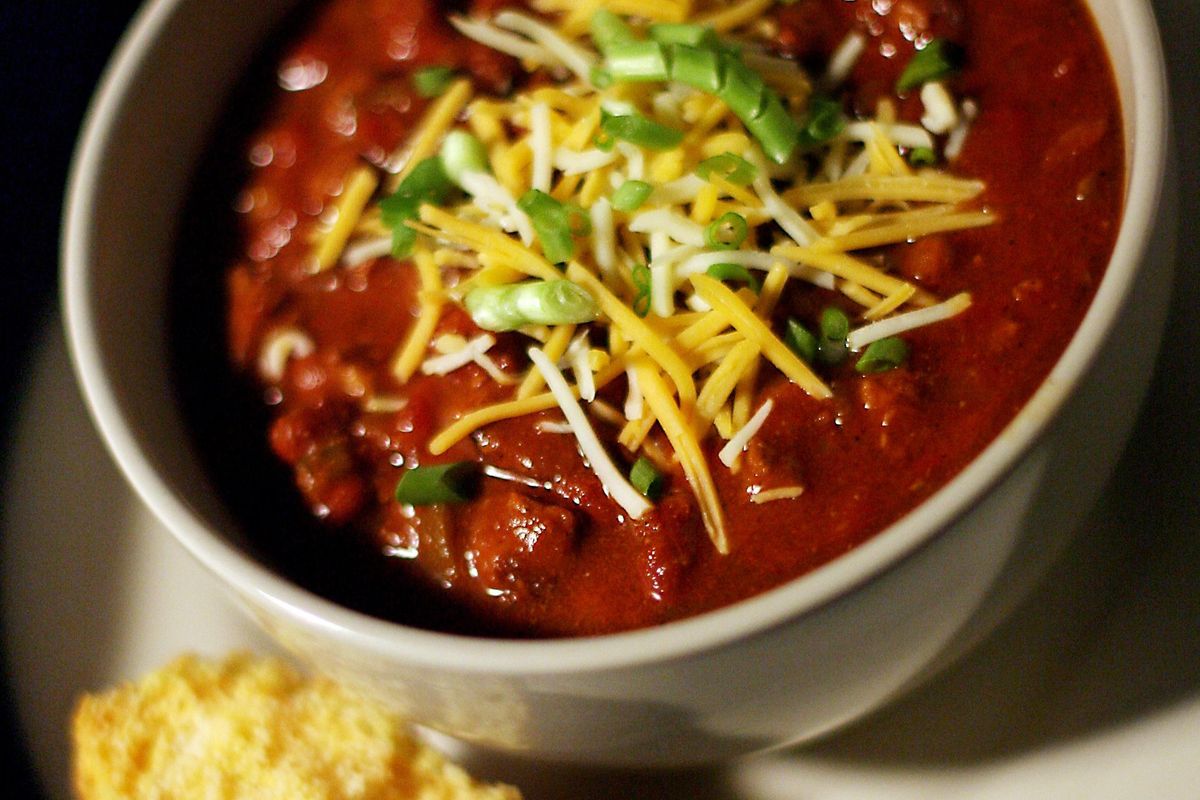 Chili garnished with cheese and scallions and served with a side of cornbread is perfect for a cold winter night. (AMY LEANG / Amy Leang/Detroit Free Press)