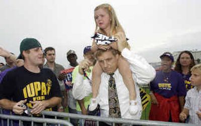 
Three-year-old Sophia Parlock cries while seated on the shoulders of her father, Phil Parlock, after their Bush-Cheney sign was torn up by Kerry-Edwards supporters Thursday at the Tri-State Airport in Huntington, W.Va. Democratic vice presidential candidate John Edwards made a brief stop at the airport as he concluded his two-day bus tour to locations in West Virginia and Ohio. 
 (Associated Press / The Spokesman-Review)