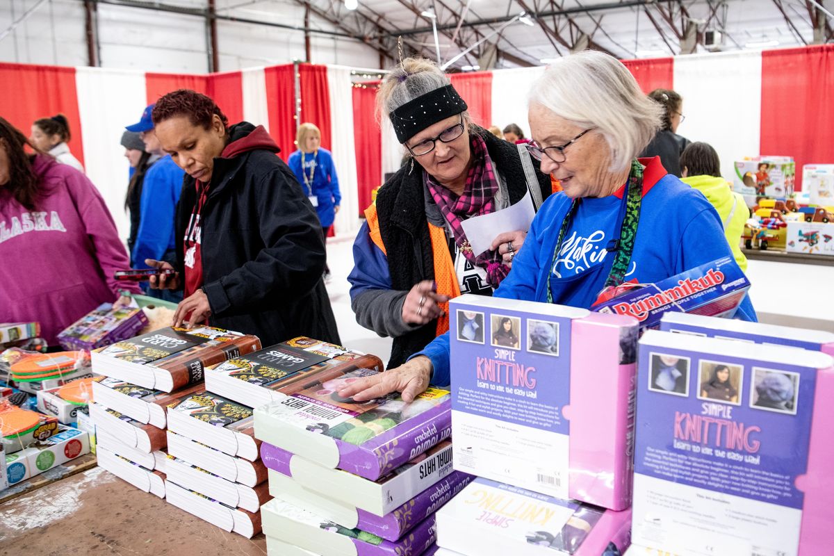 Mamie Higby, with headband, is helped by Christmas Bureau volunteer Lenny Kostelecky, right, to pick out toys for her grandchildren in the toy room at the Bureau Friday, Dec. 20, 2019, the last day of the annual toy giveaway.  Jesse Tinsley/THE SPOKESMAN-REVIEW (Jesse Tinsley / The Spokesman-Review)