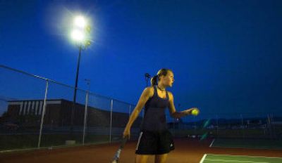 
Bailey Shepherd  prepares to serve during a match at the University High School tennis courts Thursday night. 
 (CHRISTOPHER ANDERSON / The Spokesman-Review)