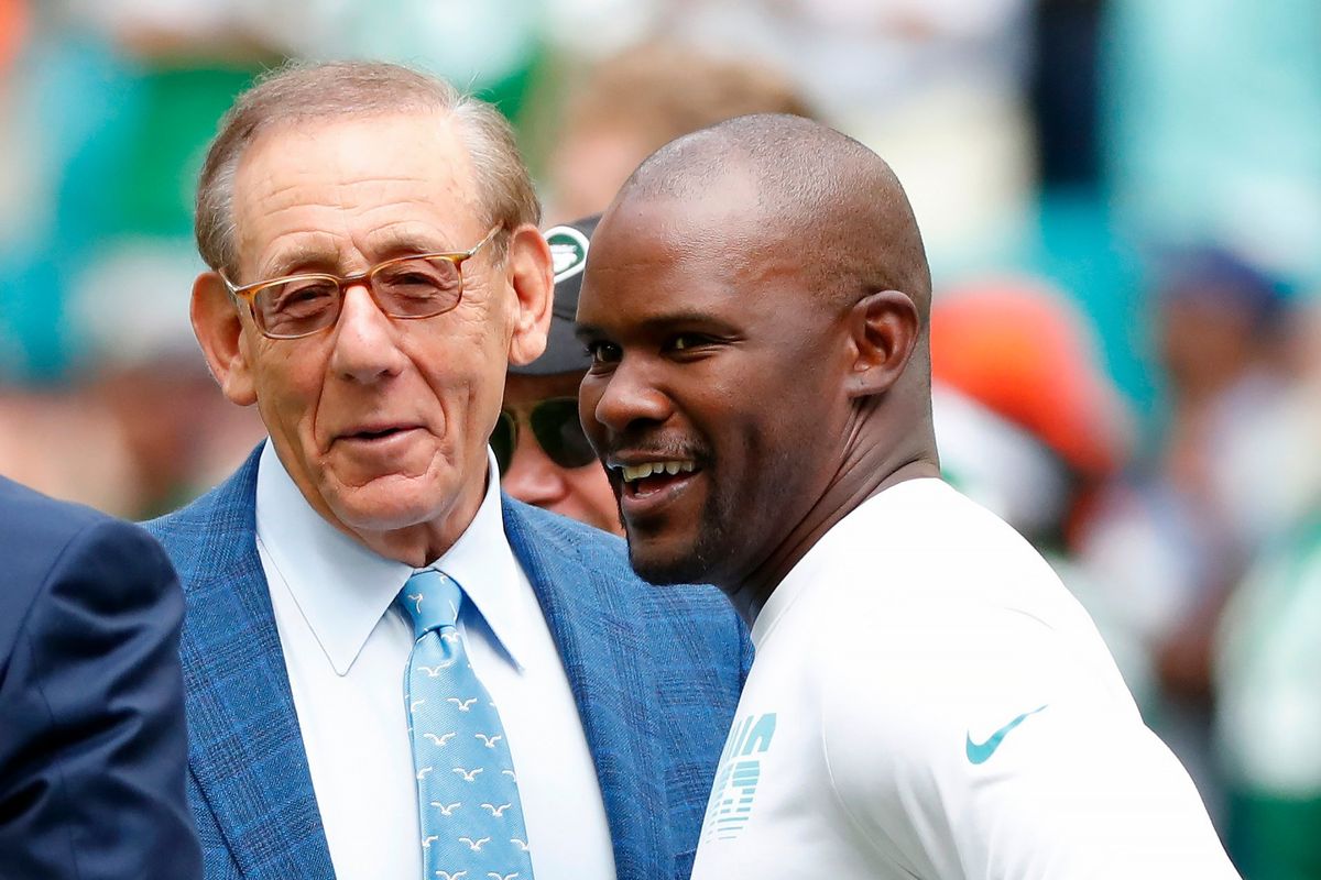 FILE -Miami Dolphins head coach Brian Flores talks to Miami Dolphins owner Stephen M. Ross during practice before an NFL football game against the New York Jets, Sunday, Nov. 3, 2019, in Miami Gardens, Fla. Fired Miami Dolphins coach Brian Flores sued the NFL and three of its teams Tuesday, Feb. 1, 2022 saying racist hiring practices by the league have left it racially segregated and managed like a plantation. (Wilfredo Lee)
