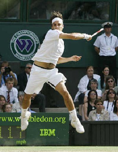
Defending champion Roger Federer returns to Spain's Rafael Nadal during the Men's Singles final. Federer earned his fourth straight Wimbledon title, beating Nadal in four sets.
 (Associated Press / The Spokesman-Review)