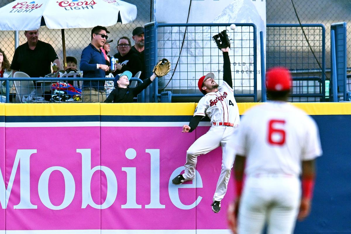 Spokane Indians outfielder Tommy Hopfe just misses preventing a solo home run by Tri-City