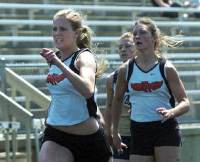 
Priest River's Lacy Hopkins, left, slips ahead on the way to her win in the 200-meter run. 
 (Jesse Tinsley / The Spokesman-Review)