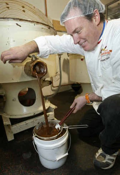 
Chocolatier Jacques Torres unleashes a torrent of chocolate from one of his chocolate-making machines at his Chocolate Haven in New York City.
 (Associated Press photos / The Spokesman-Review)