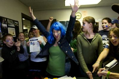 
Northwood Middle School teacher Tina Ediger, center, celebrates with her class after learning Principal Dave Stenersen would change the answers to some of the questions on the Secret Super Bowl Trivia Quiz each homeroom took Friday in order to win a pizza party. 
 (Kathryn Stevens / The Spokesman-Review)