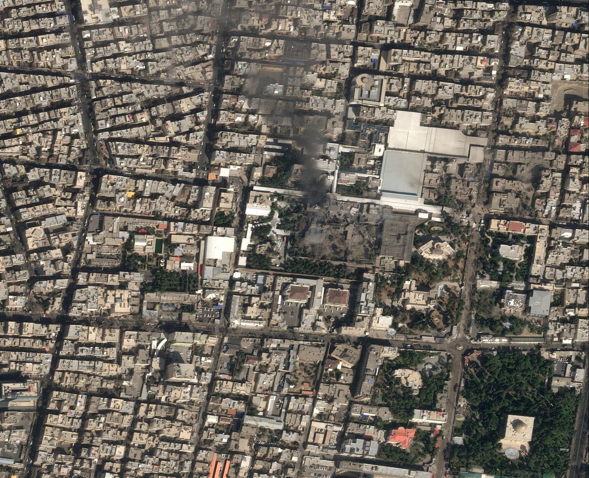 A satellite image shows black smoke rising and heavy damage at Iranian Supreme Leader Ayatollah Ali Khamenei