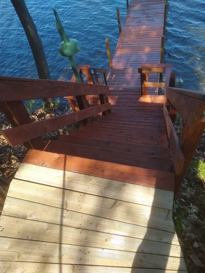 The steps, railing and boat dock are cleaned and sealed. The top walkway is ready for the sealer.  (Tim Carter)