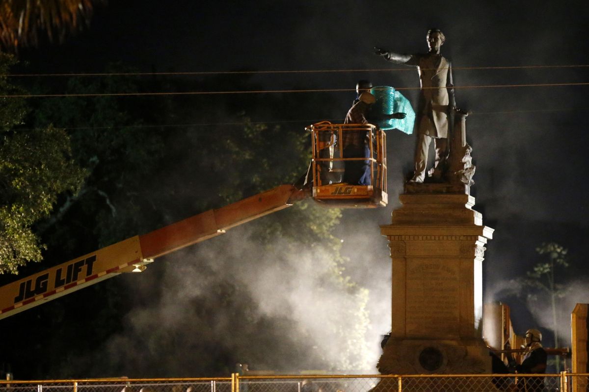 Workers prepare to take down the Jefferson Davis statue in New Orleans, Thursday, May 11, 2017. This was the second of four Confederate monuments slated for removal in a contentious process that has sparked protests on both sides. (Gerald Herbert / Associated Press)