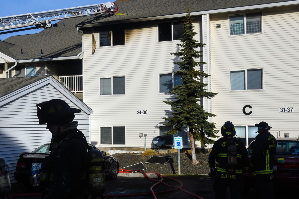 Spokane firefighters on the scene of a fire Tuesday at the Regal Ridge Apartments.  (DAN PELLE/THE SPOKESMAN-REVIEW)