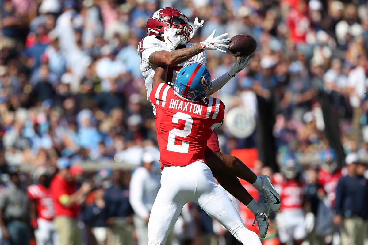 Washington State receiver Tony Freeman catches a pass against Ole Miss defender Jaylon Braxton during the second half at Vaught-Hemingway Stadium on Saturday in Oxford, Mississippi. (Getty Images)