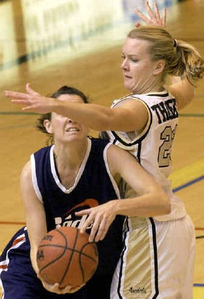 
Idaho's Heather Thoelke, right, attempts to block a shot by Baden Sports' Julie Lemery last weekend at Memorial Gym in Moscow. 
 (Rajah Bose / The Spokesman-Review)
