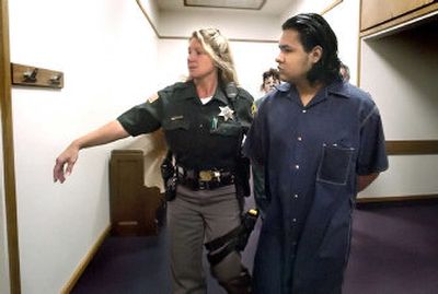 
Deputy Annette Ahlf leads Fernando Trejo-Ramirez into Judge Neal  Rielly's courtroom Wednesday. 
 (Joe Barrentine / The Spokesman-Review)