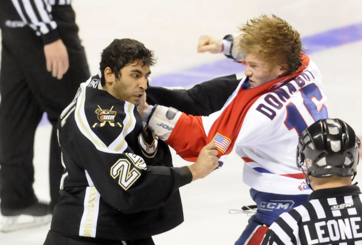 The Spokesman-Review Spokane’s Dustin Donaghy, right, swings at Chilliwack’s Partik Bhungal during a second-period fight. (Jesse Tinsley / The Spokesman-Review)