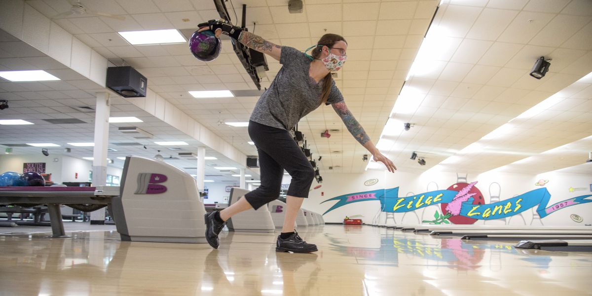 Adrienne Sadlo, an avid league bowler, makes her approach Wednesday at Lilac Lanes in North Spokane. Sadlo usually bowls at Players and Spectators in Spokane Valley, but Lilac Lanes was the first large bowling center to open and she was ready to take up the game again after five months off because of COVID-19 lockdowns. She even bought a new ball in the pro shop that day.  (Jesse Tinsley/The Spokesman-Review)