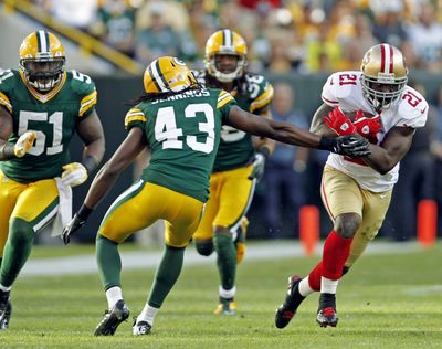 Frank Gore, right, and the 49ers got past the Packers in their first game of the season. (Associated Press)