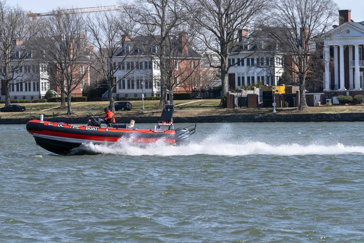 In this Friday March 19, 2021, photo a District of Columbia Fire Boat checks buoys in the waterway next to Fort McNair, seen in background in Washington. Iran has made threats against Fort McNair, a U.S. army base in Washington DC, and against the Army’s vice chief of staff, according to two senior U.S. intelligence officials, who spoke on condition of anonymity to discuss national security matters. The threats are one reason the Army has been pushing for more security around the base, which sits alongside the bustling Waterfront district of Washington DC. (Jacquelyn Martin)