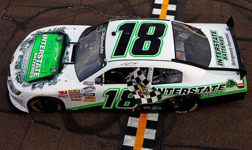 Kyle Busch drives to Victory Lane with the checkered flag after winning the Bashas' Supermarkets 200 at Phoenix International Raceway. (Photo Credit: Tom Pennington/Getty Images) (Tom Pennington / Getty Images North America)